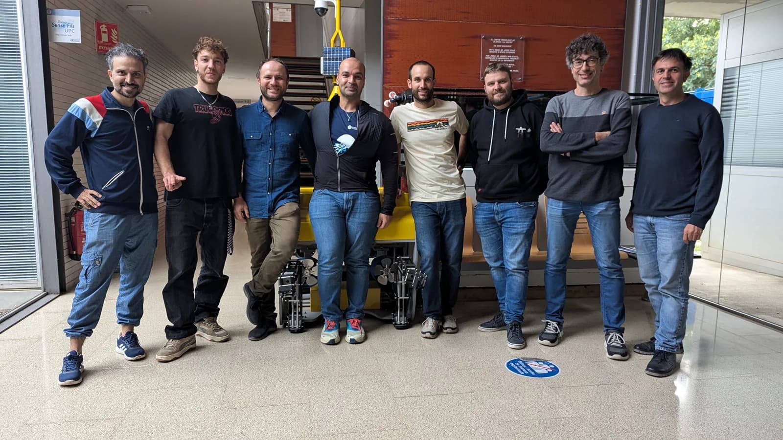 Arman Neyestani with research colleagues beside underwater vision equipment.